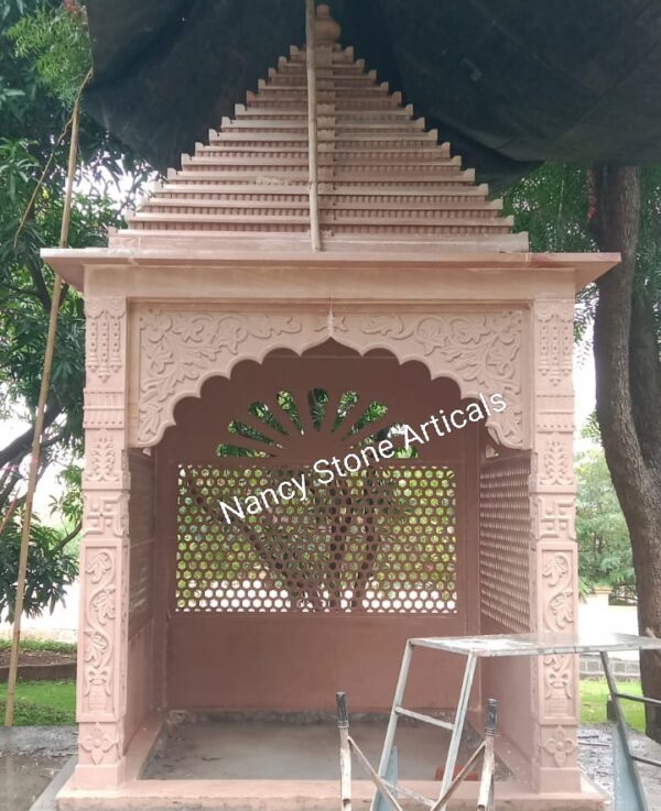 Pink sandstone temple with traditional carved architecture